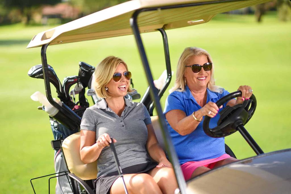 golfers on golf cart